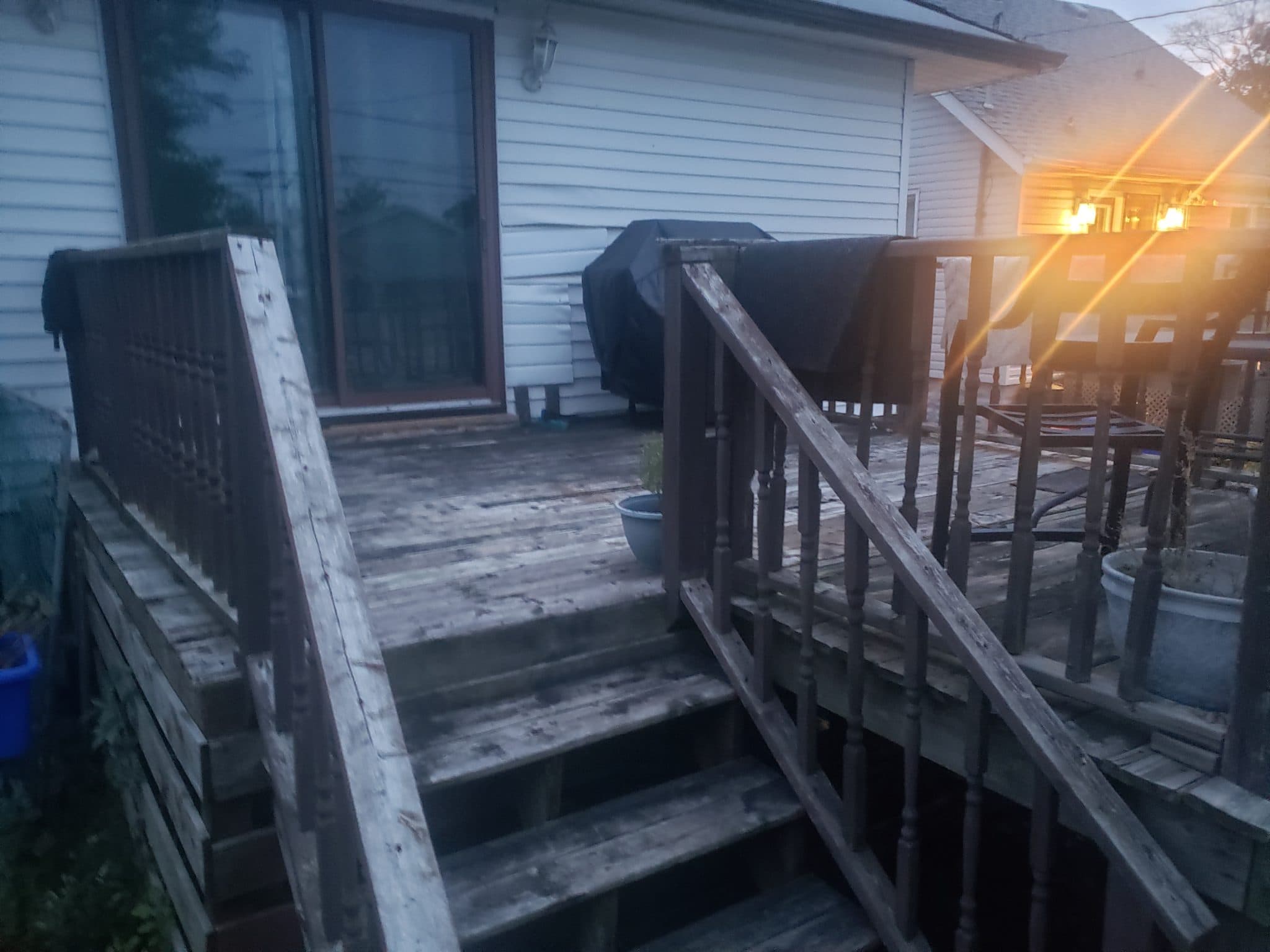 Weathered wooden deck railing before the upgrade