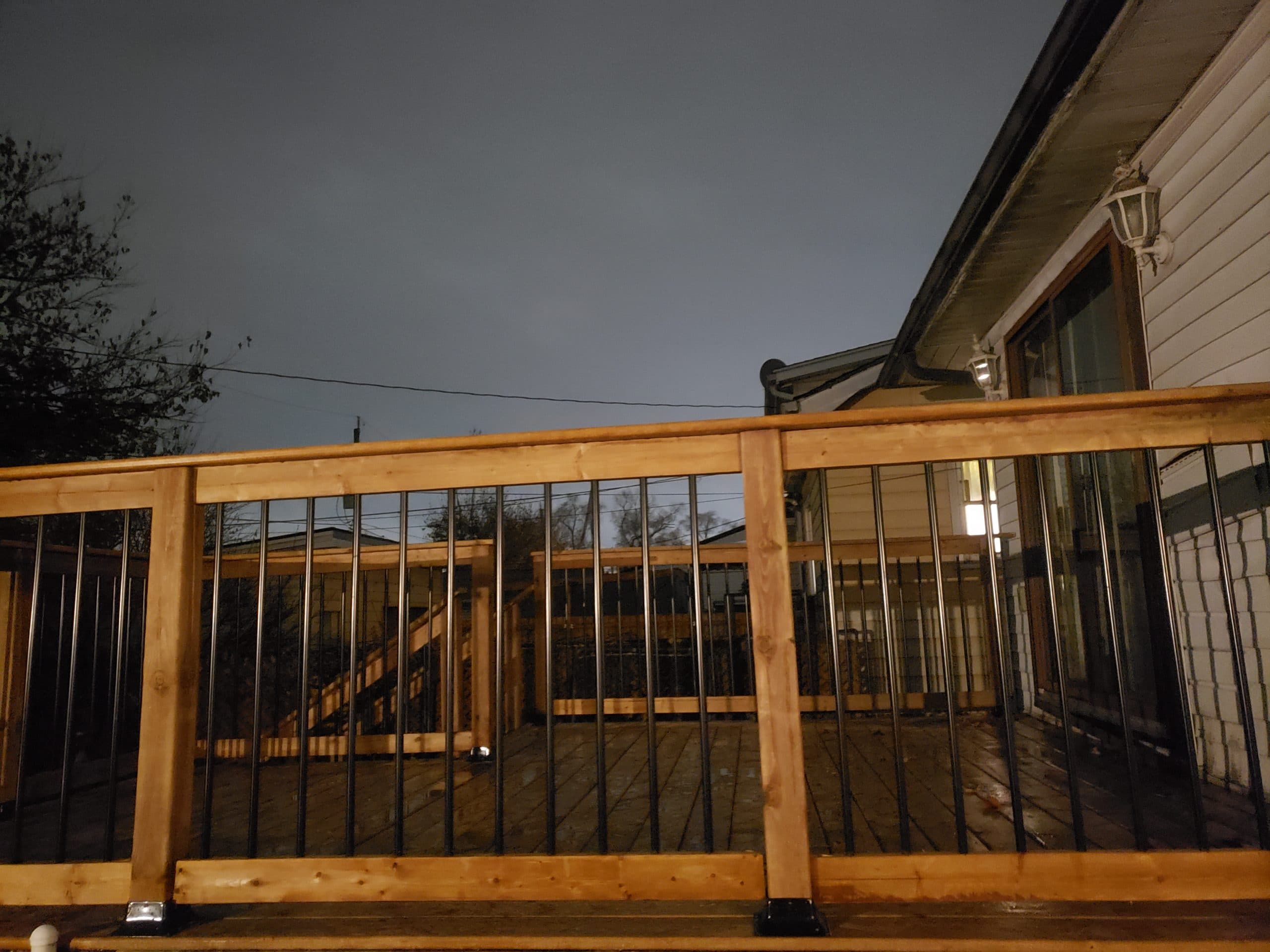 New cedar deck railing with black metal spindles
