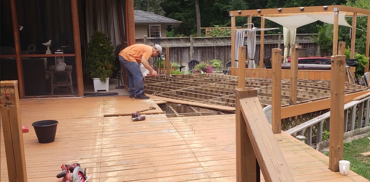 New deck framing and joists being installed mid-project